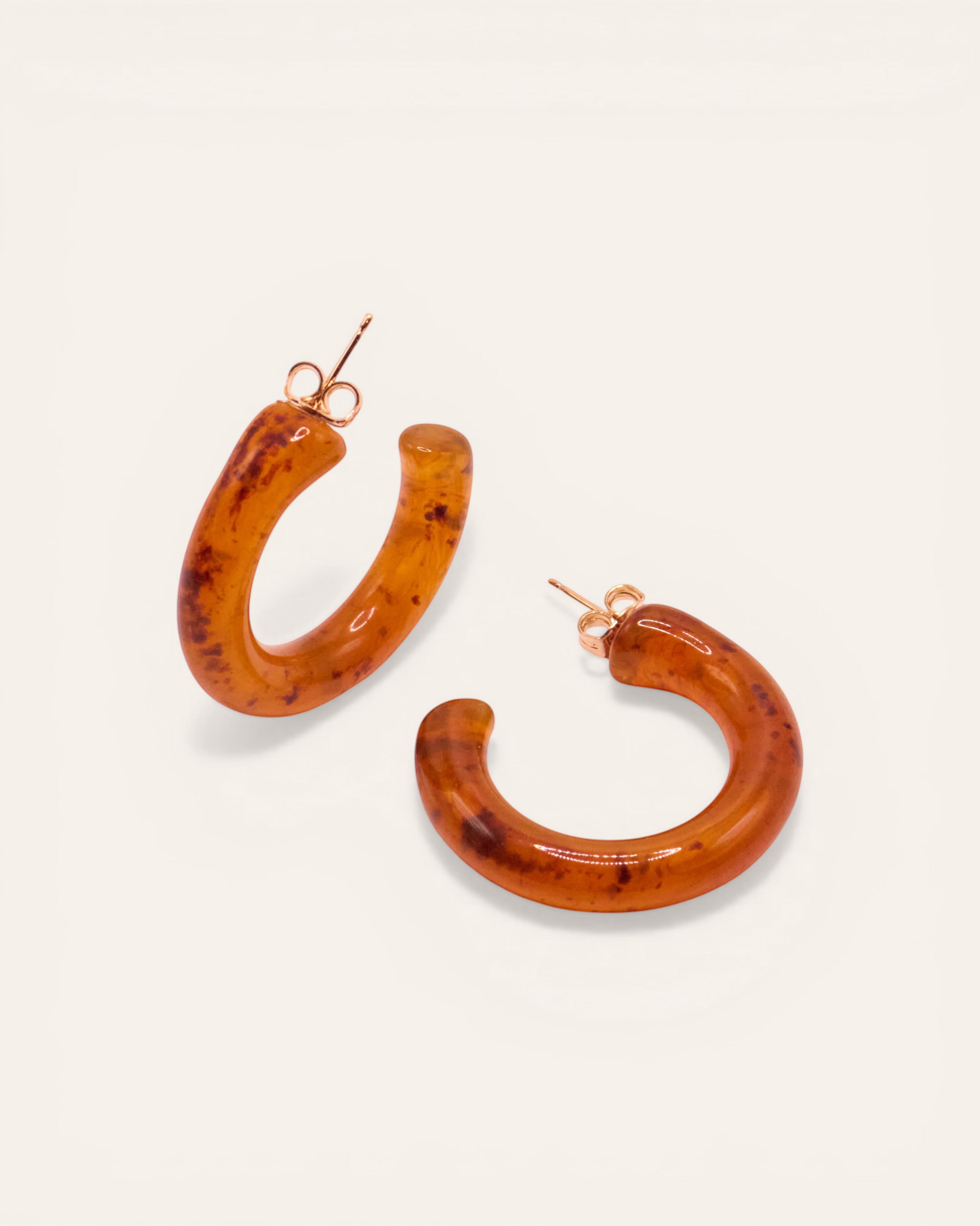 Aglaia Clara resin hoop earrings in light brown marbled pattern. Unique, lightweight, and stackable.