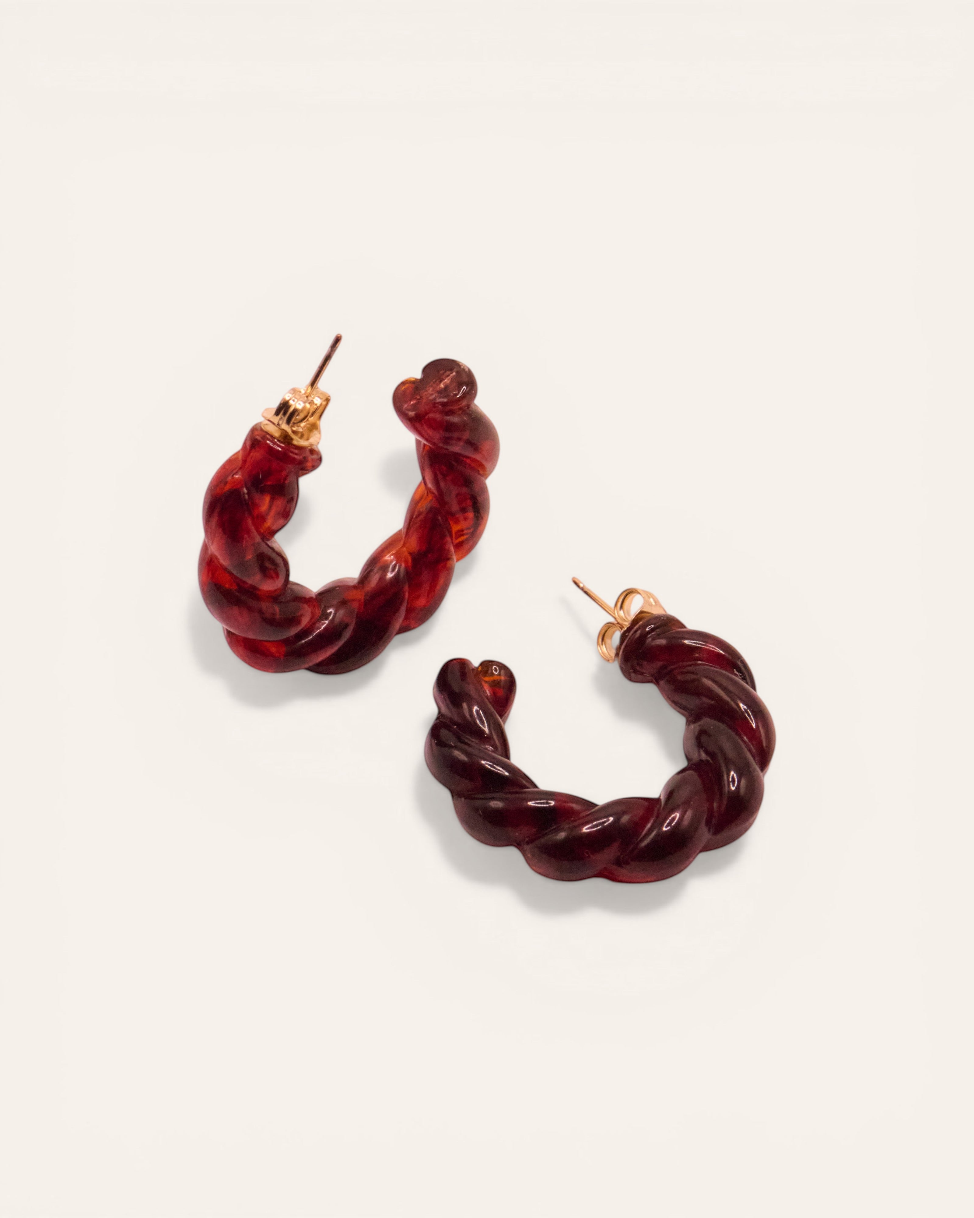 Aglaia dark brown resin twisted hoop earrings with unique marbling. Small size, suitable for stacking.