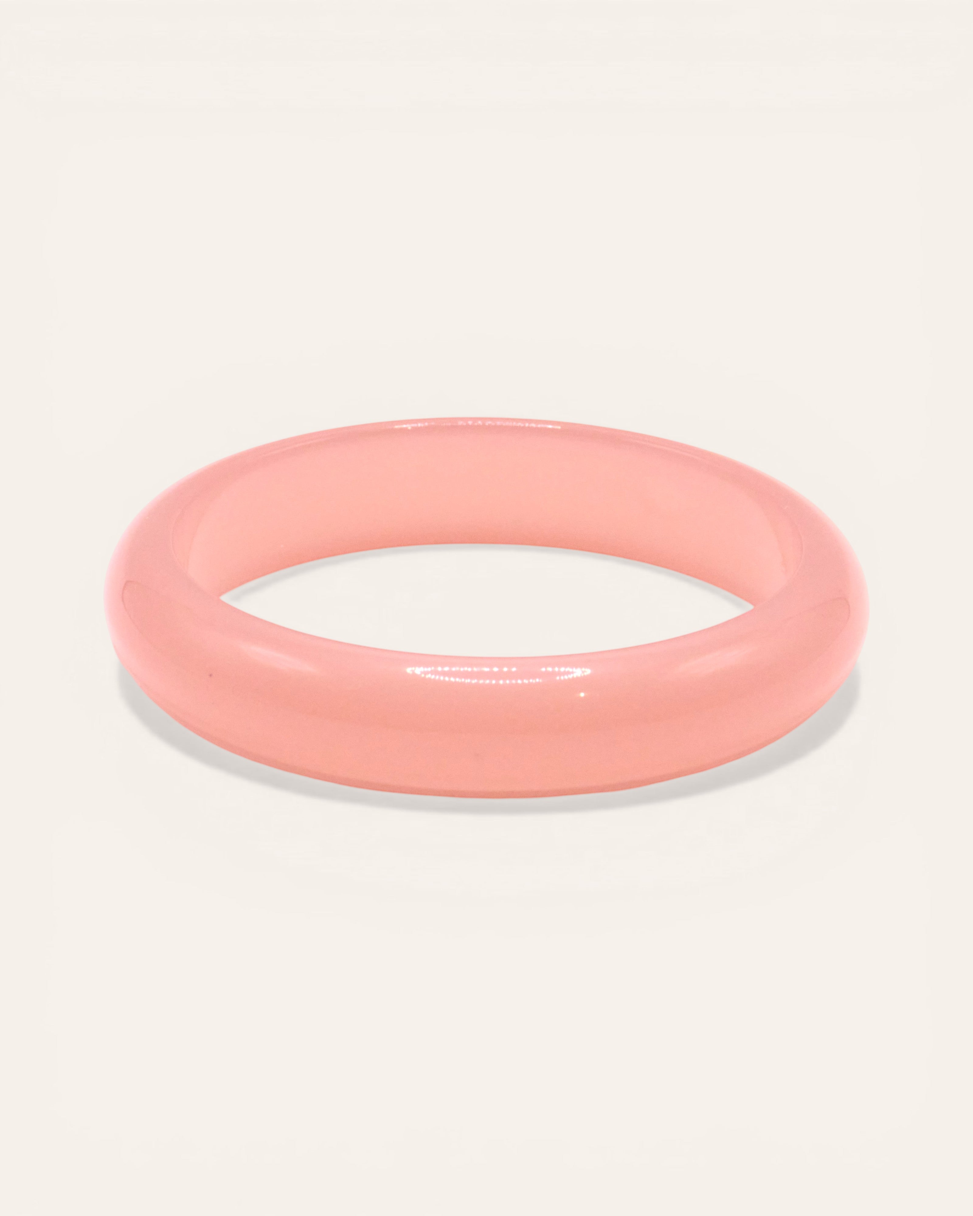 Aglaia Clara Fin thin resin bangle bracelet in light pink with unique marbling effect.