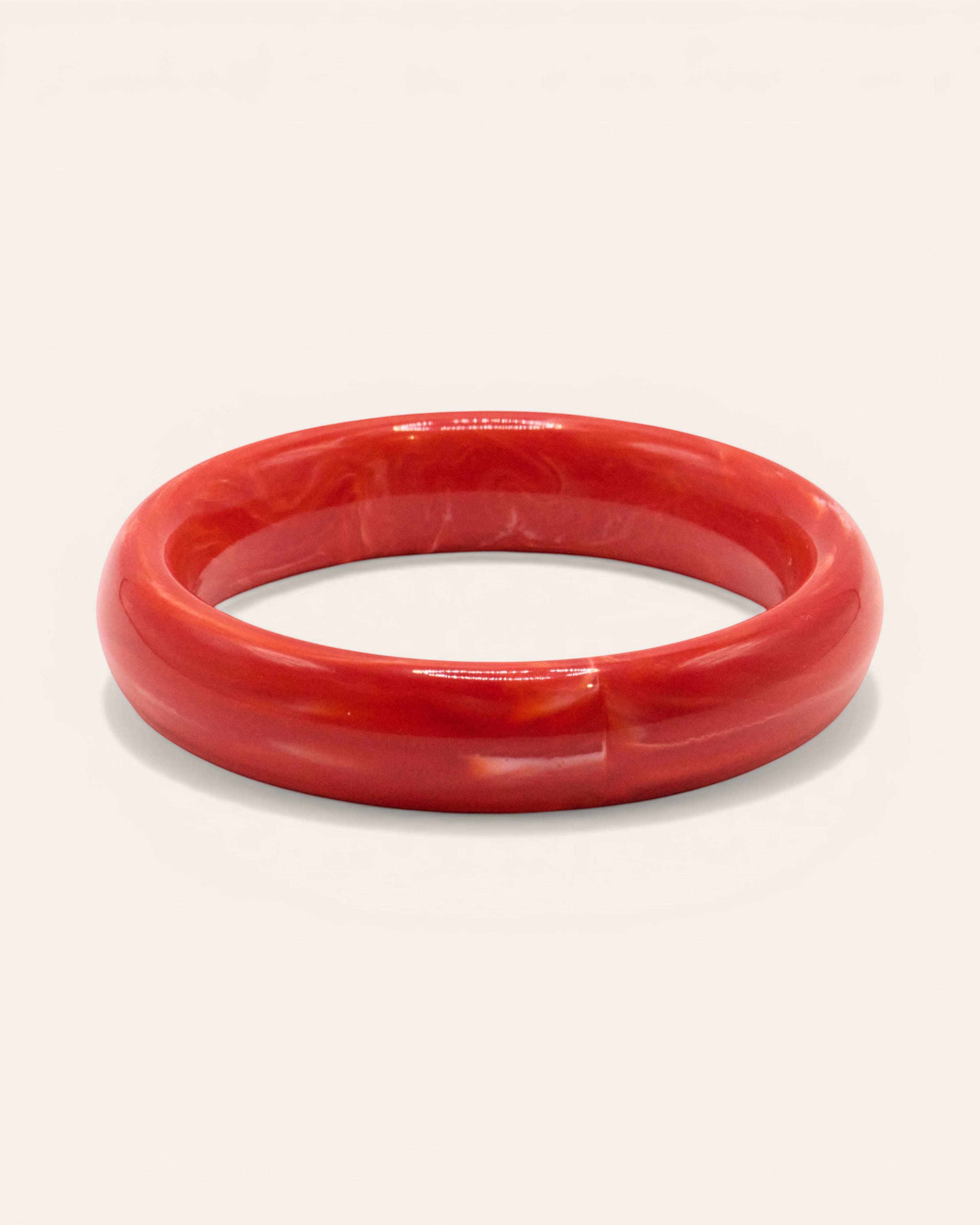 Aglaia red marbled resin bangle bracelet, unique swirling pattern, medium size.