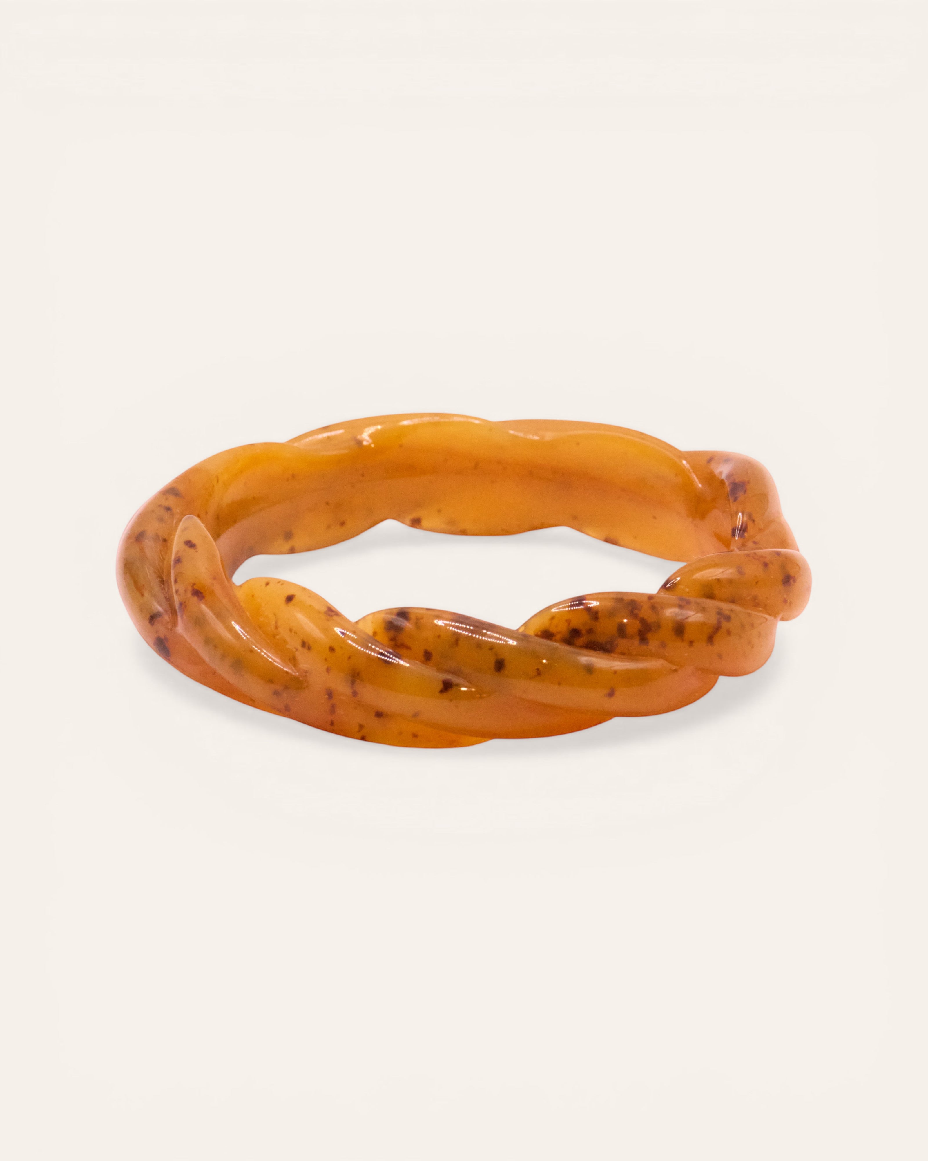 Aglaia twisted resin bangle bracelet in marbled brown and amber tones. Unique marbled pattern.