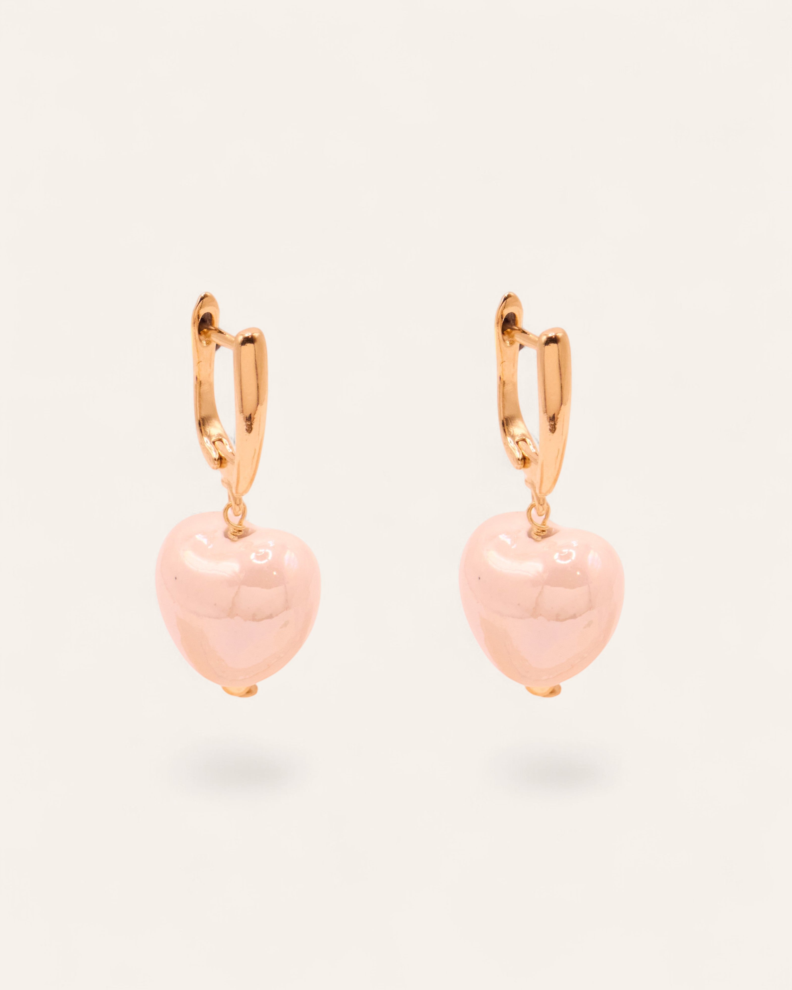 Aglaia gold-plated dormeuse earrings with white ceramic heart charms. Unique marbled design.