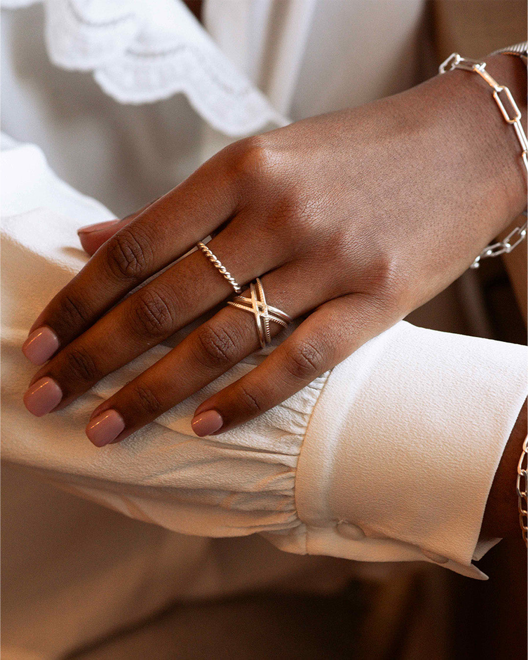 Ethical ring set comprising a fine adjustable twisted ring and a double crossed ring forming a cross, made in France.