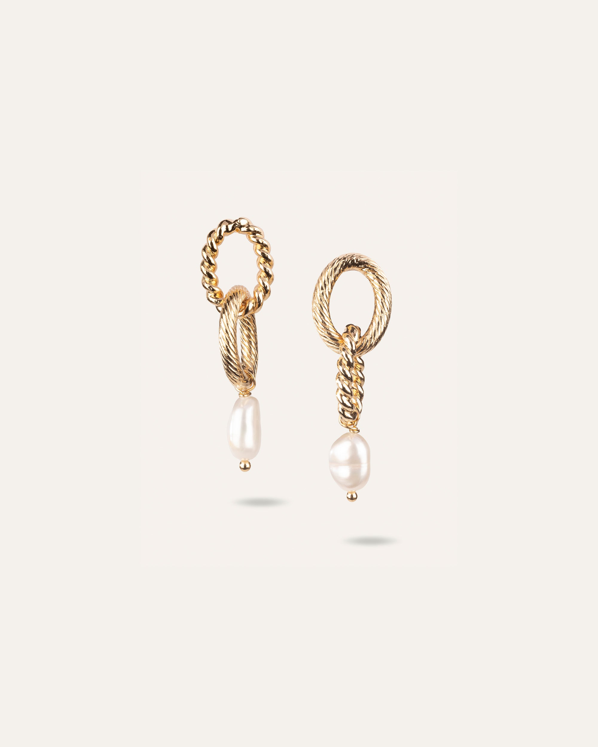 Boucles d'oreilles asymétriques composées d'une perle de culture ovale en plaqué or 3 microns et made in France.